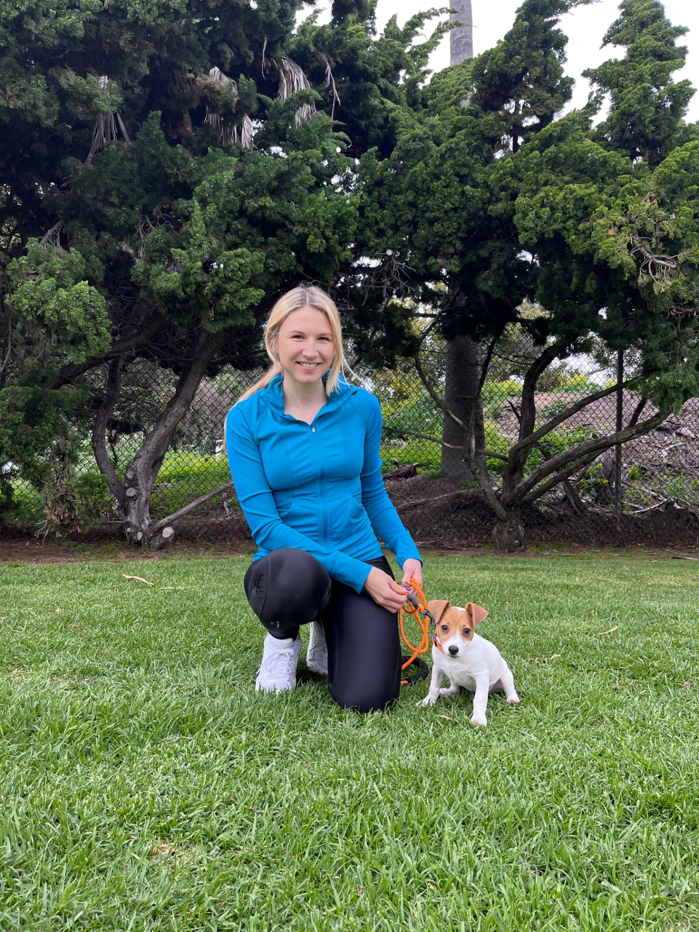 Anastasiia with a Jack Russell puppy starting foundation work on-leash
