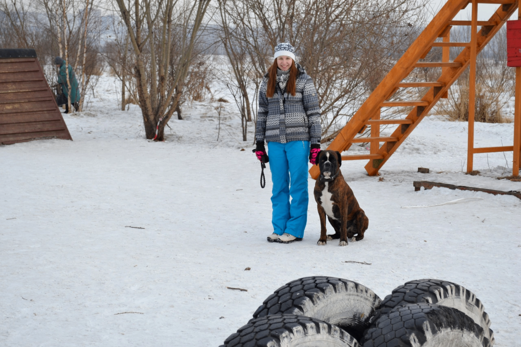 Anastasiia working a Boxer at an outdoor training facility in the snow
